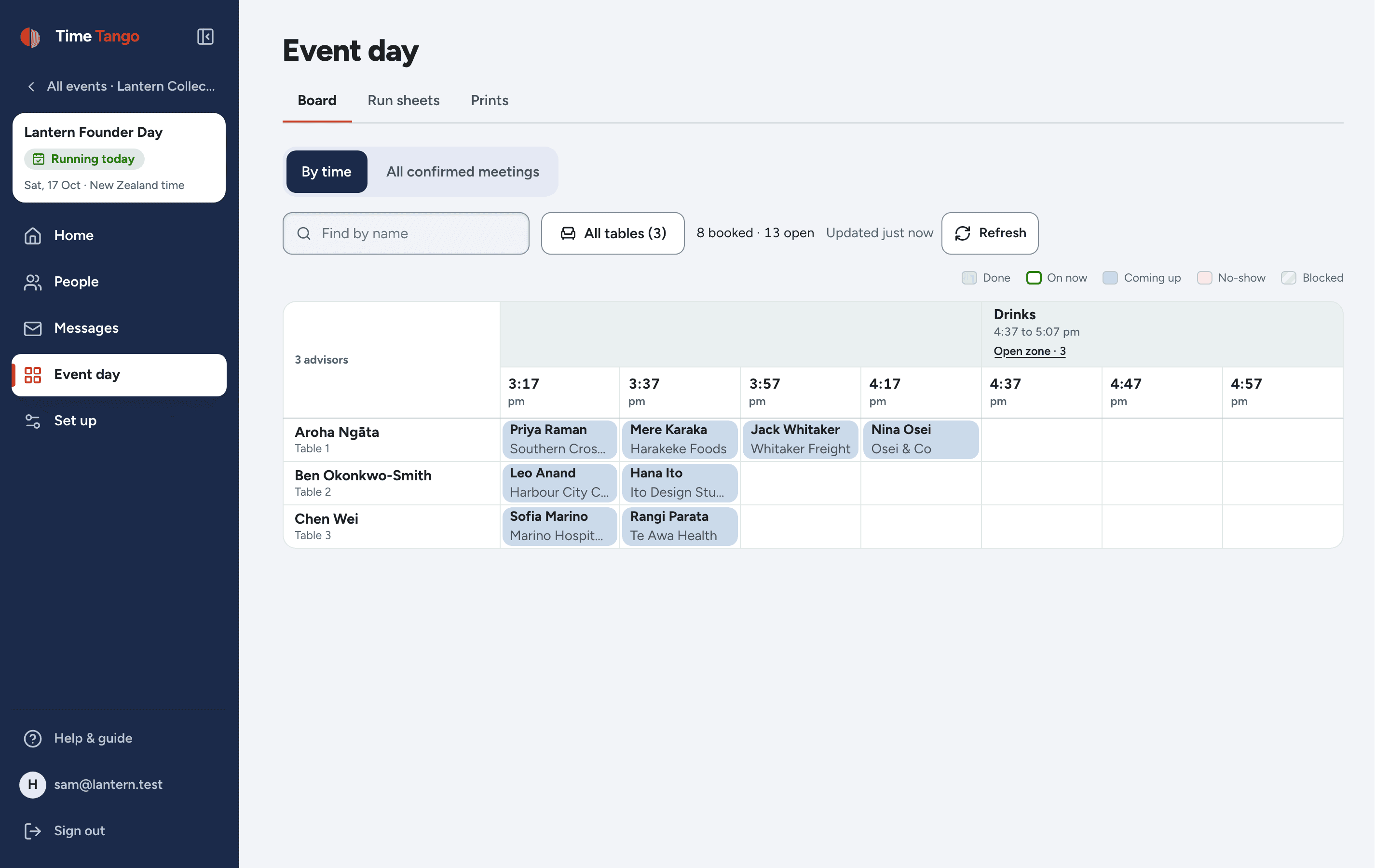 The live board on the day: advisors down the side, times across the top, each booked meeting in its cell, and the Drinks meeting block showing how many guests are meeting each other in the open zone
